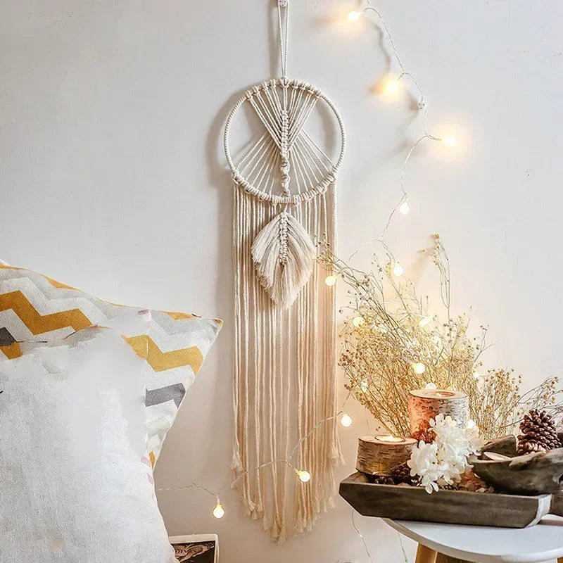 Dreamcatcher hanging on a wall with decorative elements and string lights.