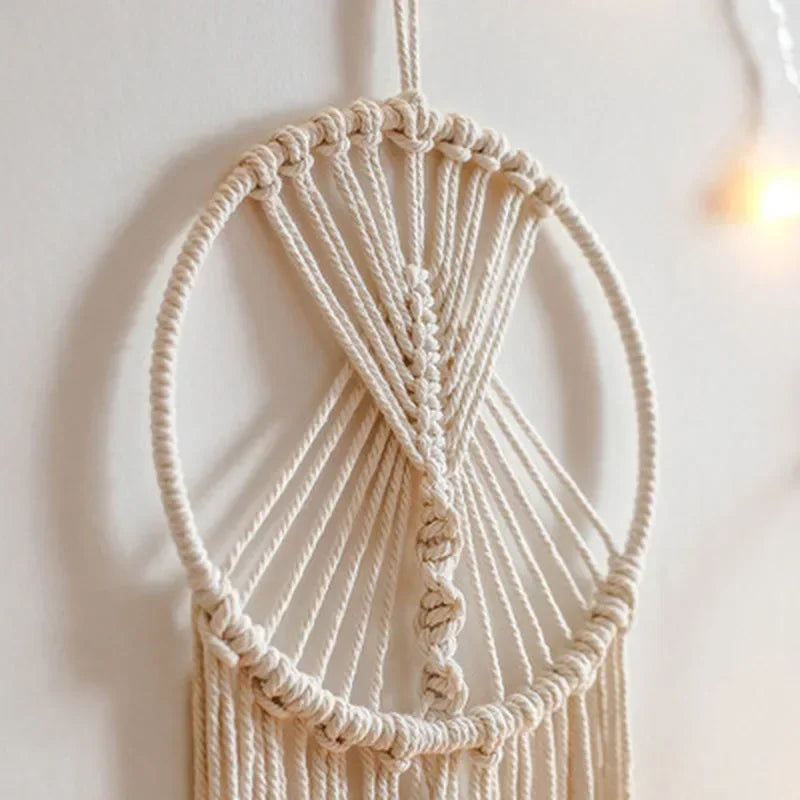 Macrame wall hanging with natural fibers against a light background