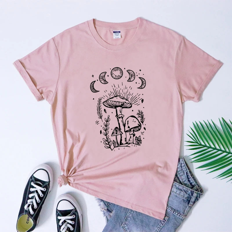 Pink t-shirt with mushroom design, paired with blue jeans and black sneakers on a white background.