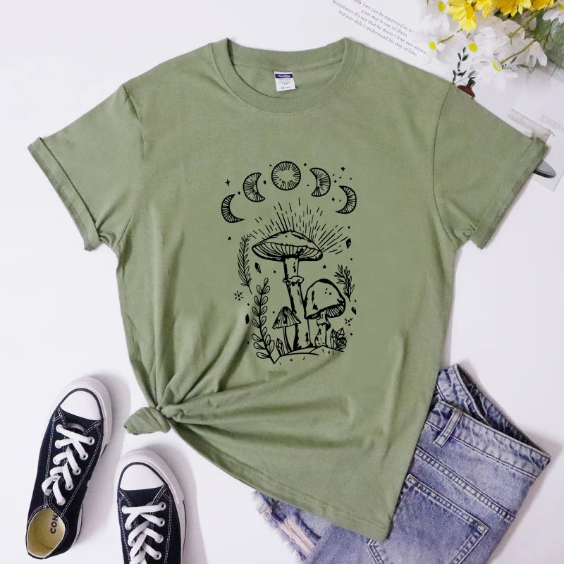 Green t-shirt with black graphic design, paired with black sneakers and blue jeans on a white background.