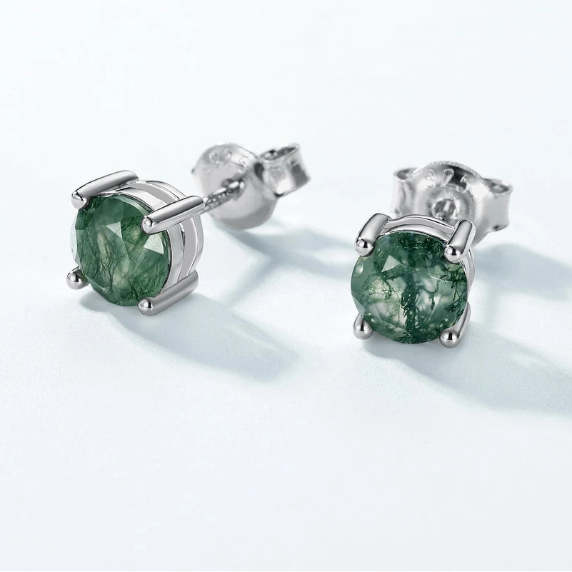 Silver earrings with green gemstones on a white background, featuring the WES brand.