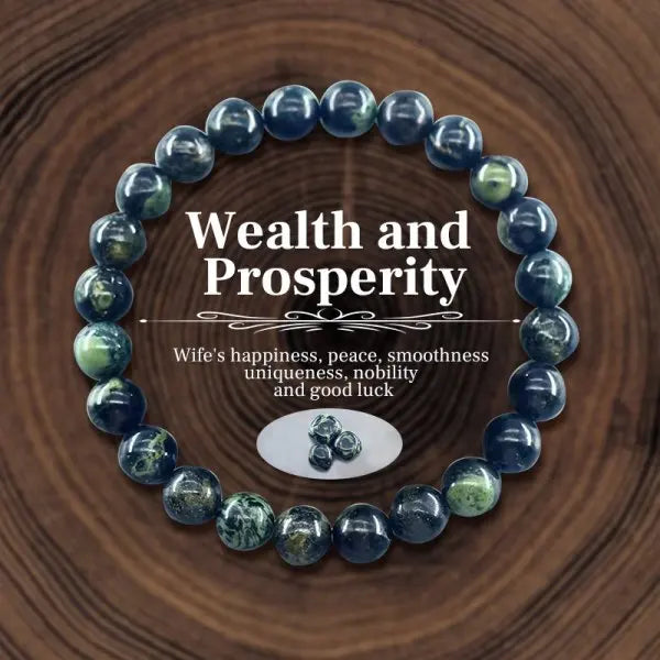 Blue beaded bracelet with 'Wealth and Prosperity' text on a wooden background