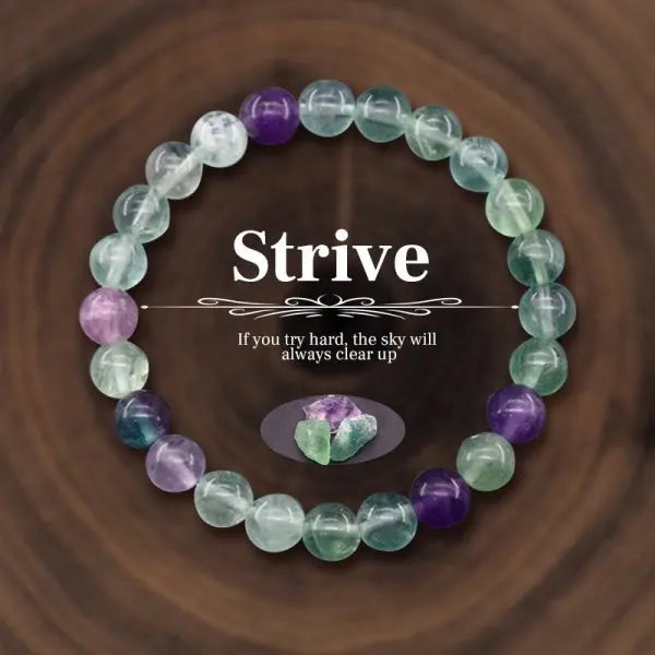 Multicolored beaded bracelet with motivational quote on a wooden surface