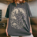 Person wearing a dark gray t-shirt with a white fox and moon design.