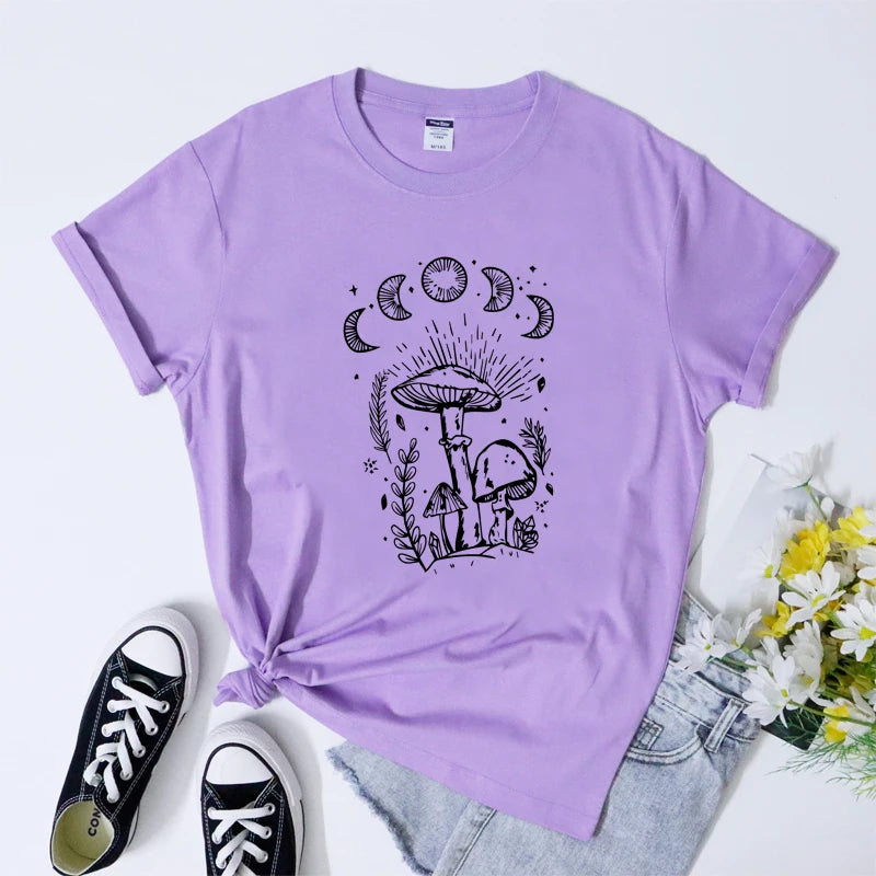 Purple t-shirt with black mushroom and moon design, paired with black sneakers and jeans on a light purple background.