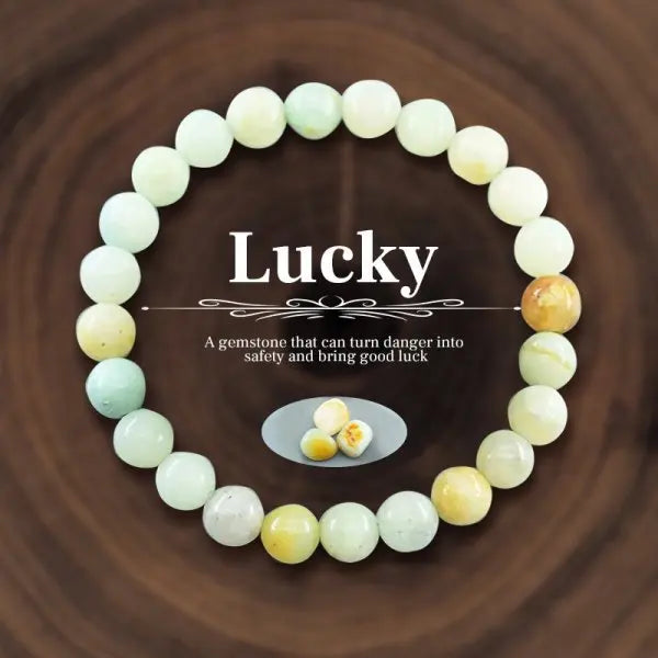 Beaded bracelet with 'Lucky' text on a wooden background