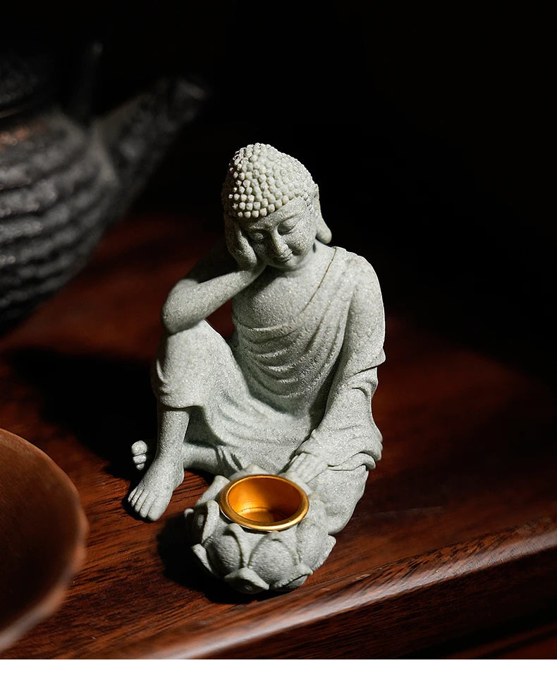 Statue of a meditating Buddha on a wooden surface with a dark background