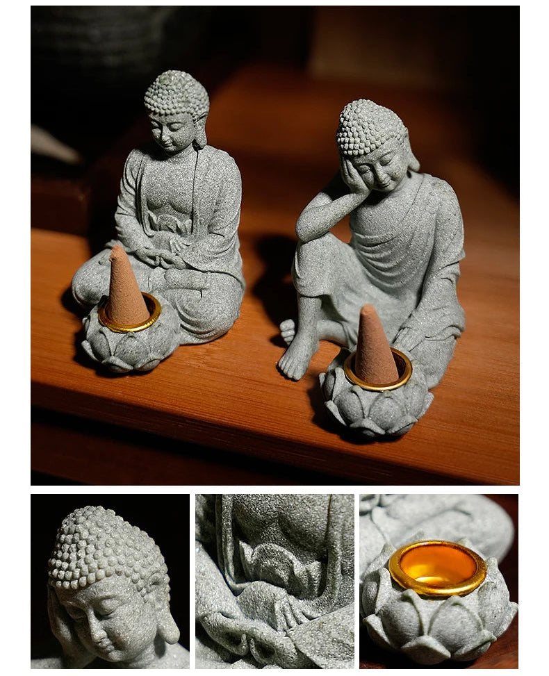 Two stone statues of Buddha on a wooden surface with close-up details.
