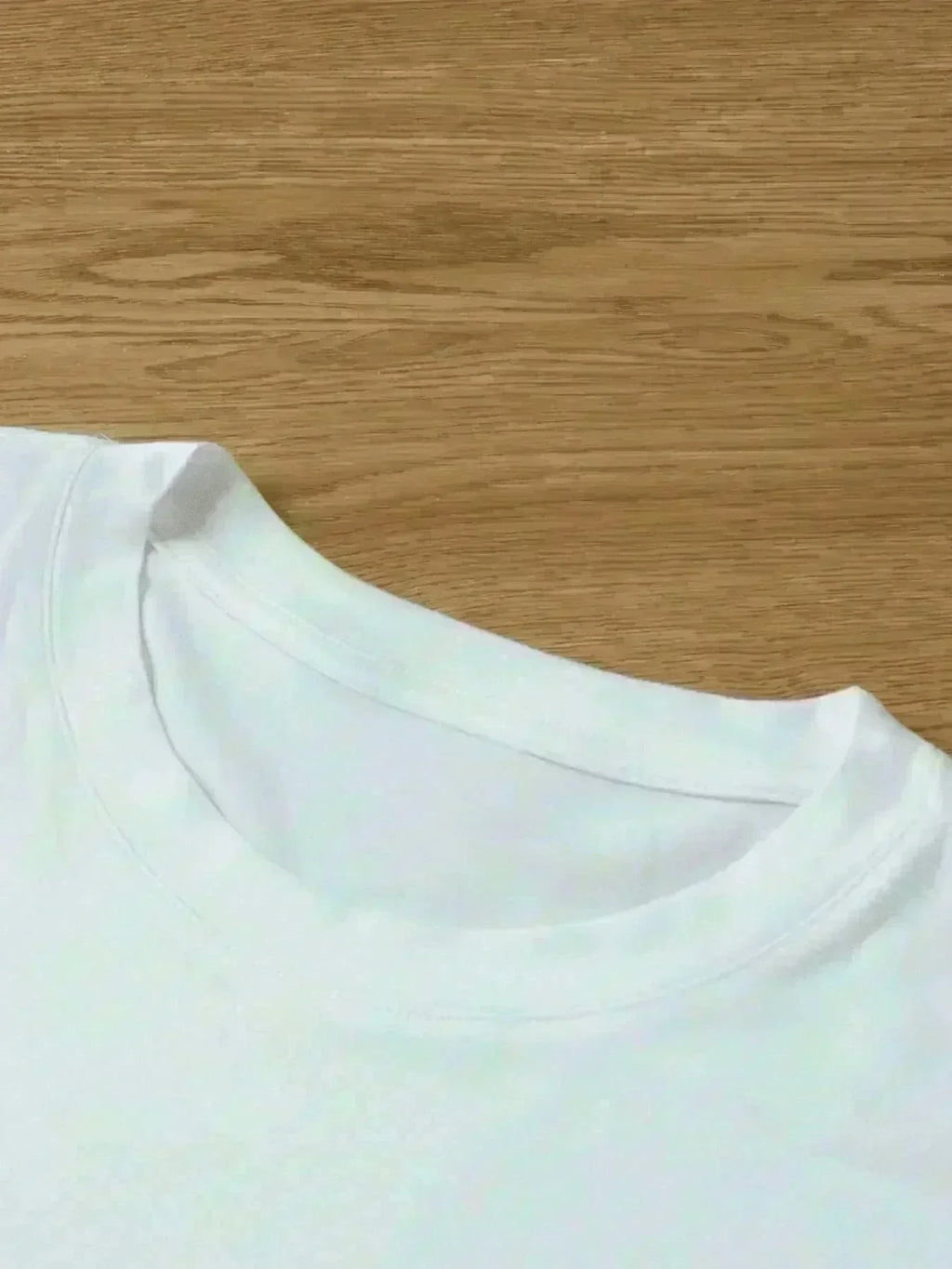 White t-shirt on a wooden surface
