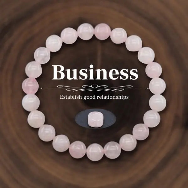 Pink beaded bracelet on a wooden surface with text 'Business: Establish good relationships'.
