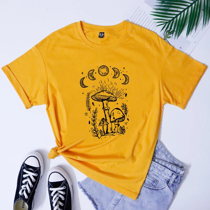 Yellow t-shirt with mushroom and moon design, paired with black sneakers and light blue jeans on a white background.